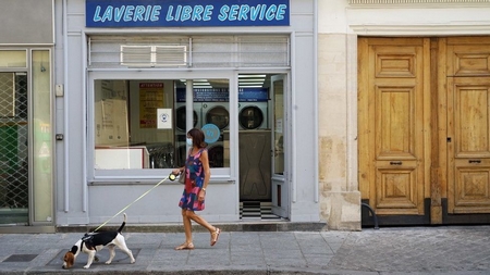 Một phụ nữ đeo khẩu trang trên đường phố Pháp - Ảnh: AFP